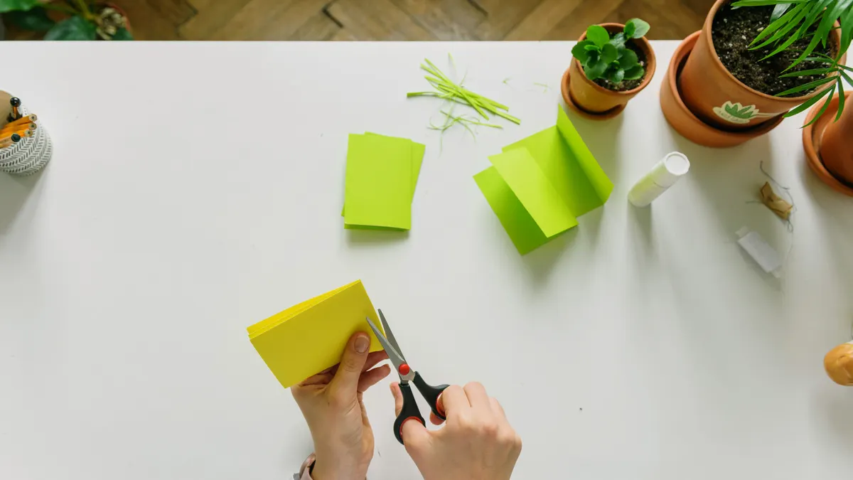 Hands folding bright paper for a simple craft project