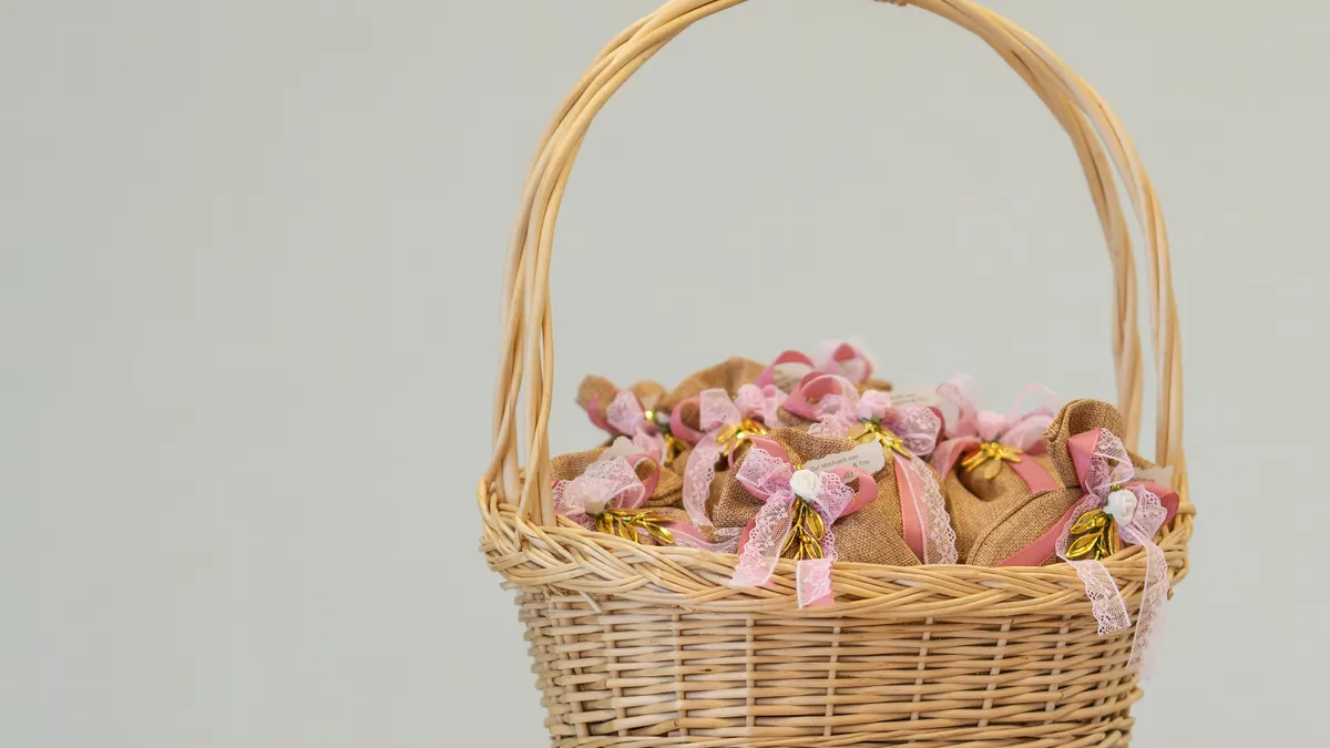 Wicker Easter basket filled with decorated eggs and pink ribbon