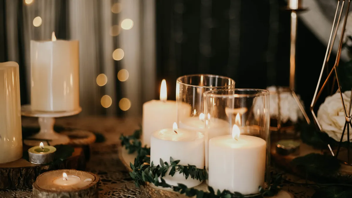 Candle centerpiece with greenery and glass holders