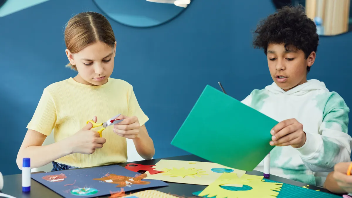 Children cutting and arranging colored paper