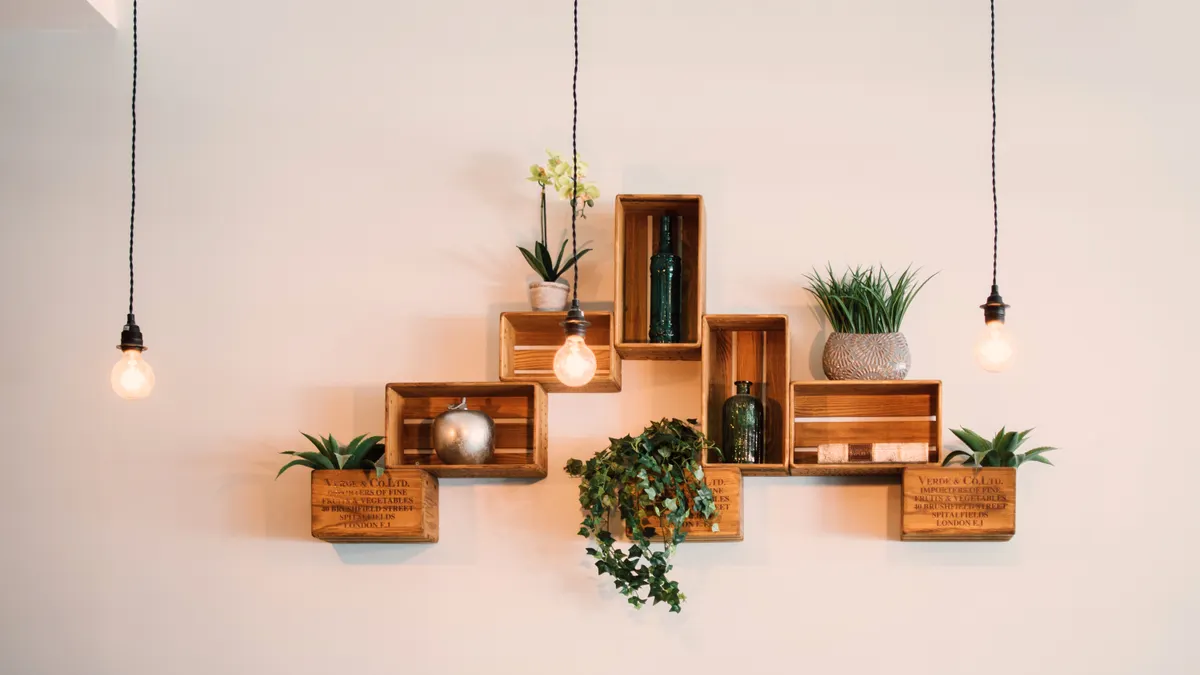 Wooden wall shelf with plants and decor