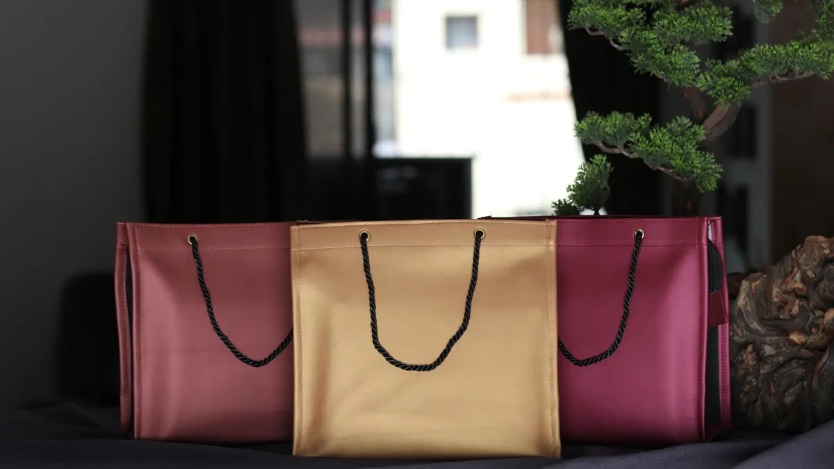 Three handmade paper gift bags with rope handles