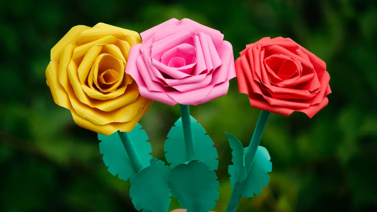 Three handmade paper roses on stems